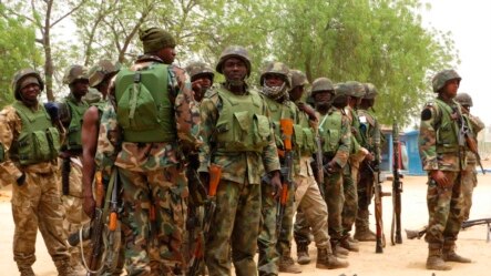 Soldiers stand during a parade in Baga village on the outskirts of Maiduguri, in the north-eastern state of Borno May 13, 2013. To match Insight NIGERIA-ISLAMISTS-INSIGHT/     REUTERS/Tim Cocks (NIGERIA - Tags: MILITARY CIVIL UNREST) - RTXZKL1