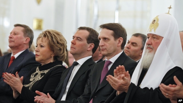 Russian dignitarites applaud before President Vladimir Putin's state-of-the nation address in the Kremlin in Moscow, Dec. 12, 2012.