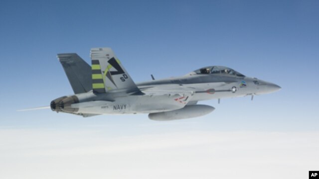 A US Navy jet assigned to the Air Test and Evaluation Squadron 23 tests a 50/50 mixture of Camellia seed-based biofuel blend over the skies of Southern Maryland on Earth Day 2010.