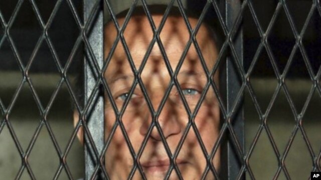 Egypt's former Housing Minister Ahmed el-Maghrabi arrives at court in a police vehicle in north Cairo (File Photo - February 23, 2011)