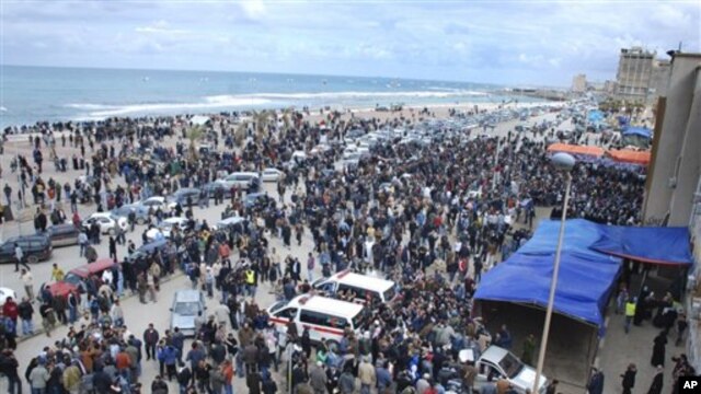 Libyan residents gather near the courthouse in Benghazi, Libya, February 23, 2011