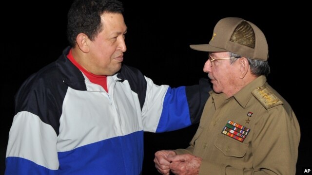 In this picture released Tuesday, Dec. 11, 2012 by Cuba's state newspaper Granma, Cuba's President Raul Castro, right, receives Venezuela's President Hugo Chavez at the Jose Marti International Airport in Havana, Cuba on Dec. 10, 2012. 