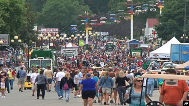 A crowd walks along part of the fair grounds at the Iowa State Fair, in the state capital Des Moines, August 12, 2011