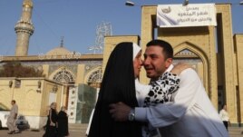Iraqi Sunni Muslims exchange greetings after Eid prayers outside Abu Hanifa mosque at the first day of Eid al-Fitr prayers in Baghdad, Iraq, August 19, 2012. 