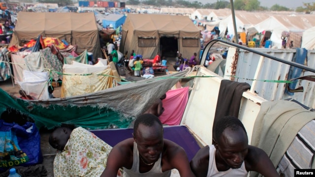 Displaced men rest in an improvised shelter at an UNMISS base in Juba, where nearly 30,000 people who were forced from their homes when violence erupted in South Sudan have sought shelter. 