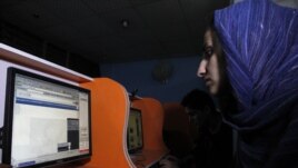 An Afghan woman browses the YouTube website at a public internet cafe in Kabul. Like Afghanistan, Indonesia seeks to ban the YouTube website showing a U.S.-made film insulting the Prophet Mohammad, Sept. 12, 2012.