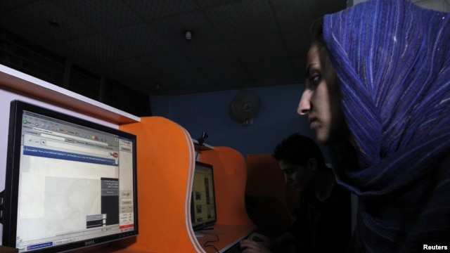 An Afghan woman browses the YouTube website at a public internet cafe in Kabul. Like Afghanistan, Indonesia seeks to ban the YouTube website showing a U.S.-made film insulting the Prophet Mohammad, Sept. 12, 2012.