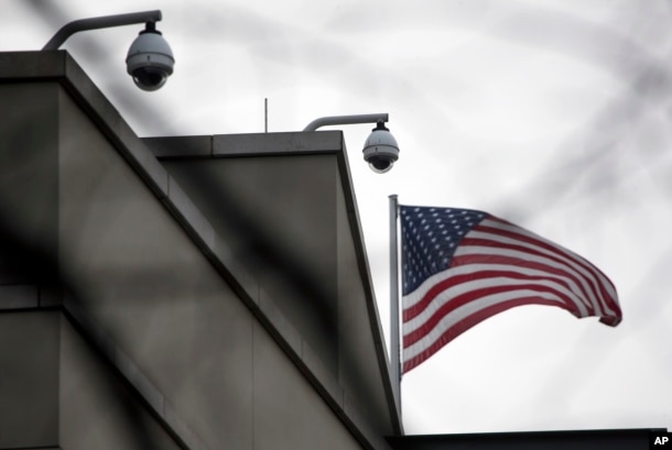 American flag waves beside CCTV cameras on top of the U.S. embassy in Berlin, Germany, Oct. 25, 2013.