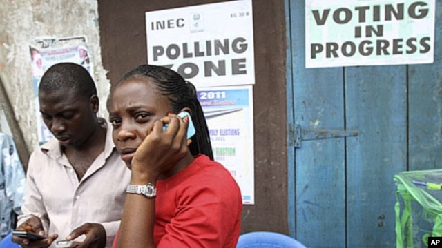 An election officer in Nigeria's commercial capital, Lagos, makes a phone call after the postponement of parliamentary elections, April 2, 2011