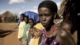 Karsi Tadicha and her children stand next to their house in Bule Duba village, on the outskirts of Moyale, Ethiopia, June 2009. (file photo)