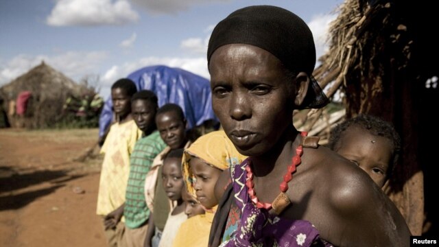 Karsi Tadicha and her children stand next to their house in Bule Duba village, on the outskirts of Moyale, Ethiopia, June 2009.