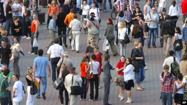 Belarusian policemen block a street during an action "Revolution via social network" in Minsk, Belarus, June 22, 2011.