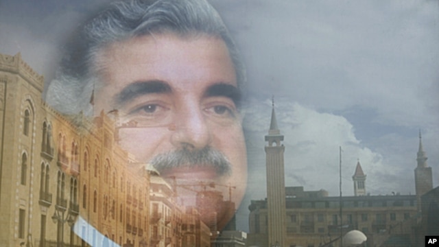 The buildings of Beirut's downtown are seen reflected on a portrait of the slain former Lebanese Prime Minister Rafik Hariri, in Beirut. (file photo)