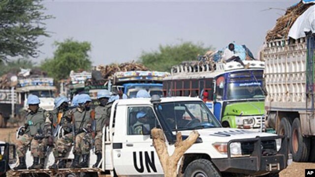 Rwandan troops with the UN-African Union peacekeeping operation in Darfur [UNAMID] escort returnees during a repatriation operation for more than 200 displaced families returning from Aramba to their original village in Sehjanna, north Darfur, Sudan, July