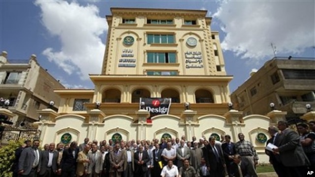 Egyptian Muslim Brotherhood Shura (Consultative) council members gather for a photo op outside the new Muslim Brotherhood headquarters in Cairo, April 30, 2011