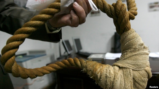 FILE - A museum worker shows a noose on display in a Iraqi museum in Baghdad, December 30, 2008.