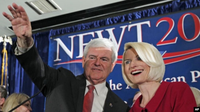 Republican presidential candidate and former House Speaker Newt Gingrich waves to the crowd with his wife Callista during a South Carolina Republican presidential primary night rally, Jan. 21, 2012, in Columbia, S.C.