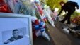 A picture of victim Drummer Lee Rigby, of the British Army's 2nd Battalion The Royal Regiment of Fusiliers is displayed with flowers left by mourners outside an army barracks near the scene of his killing in Woolwich, southeast London May 23, 2013.