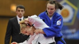 Kayla Harrison of US, in white, fights with Vera Moskalyuk of Russia during the women's under 78 kg category final match at the World Cup Judo tournament in Budapest, Hungary, February 12, 2012.