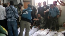Handout photo released by Syrian opposition's Shaam News Network shows UN observers at hospital morgue before their burial in central Syrian town of Houla on May 26, 2012.