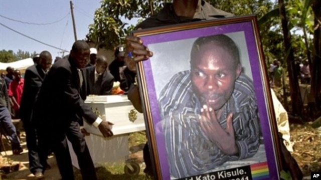 A member of the Ugandan gay community carries a picture of murdered gay activist David Kato during his funeral near Mataba, January 28, 2011.  Although the police claims it was most likely a petty crime, targeting Kato's money, many members of the gay and