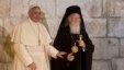 FILE - Pope Francis stands with Ecumenical Patriarch Bartholomew I as they meet outside the Church of the Holy Sepulchre, in Jerusalem's Old City, May 25, 2014. 