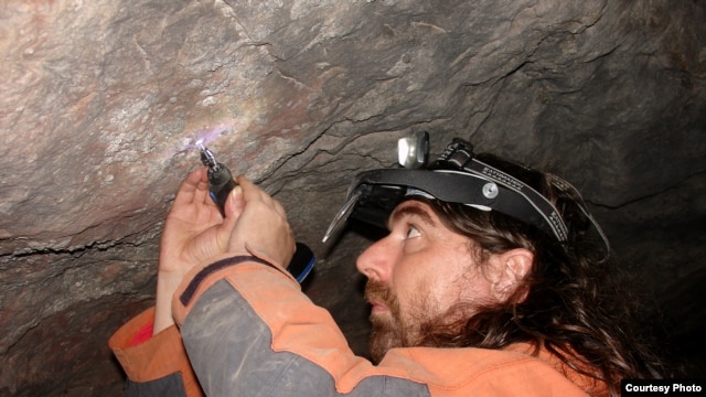 Project leader Alistair Pike of Bristol University removes calcite samples from the cave paintings for dating. As little as 10 milligrams, about the size of a grain of rice, is required. (Marcos Garcia Diez)