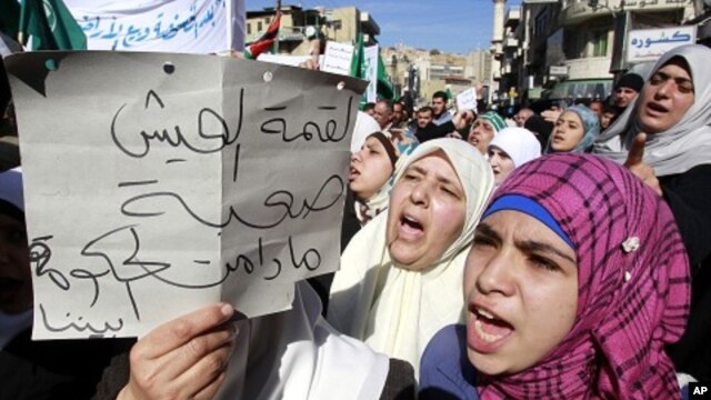 Protesters from opposition parties and labor unions shout anti-government slogans in Amman, January 28, 2011
