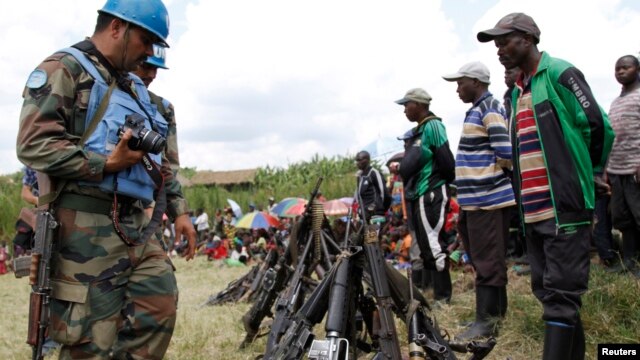 FILE - UN peacekeepers record details of weapons recovered from the Democratic Forces for the Liberation of Rwanda (FDLR) militants after their surrender in Kateku, eastern Democratic Republic of Congo, May 30, 2014.
