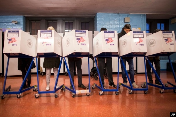 Voters fill out their forms at a polling station in the Brooklyn borough of New York, Nov. 8, 2016.