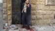 A man reacts as he stands on bloodstains at a site hit by airstrikes in the rebel-held area of Aleppo's al-Fardous district, Syria, April 29, 2016. 