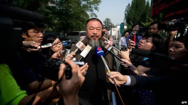 Outside a court in Beijing, Chinese artist Ai Weiwei (C) talks to the foreign media says the court rejected his appeal regarding a $2.4 million fine for tax evasion, Sept. 27, 2012.