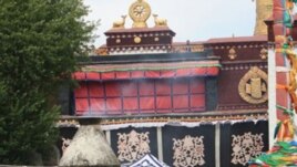 Chinese military personnel carrying fire extinguisher walks in front of Jokhang temple at Barkor Square in Lhasa, Tibet