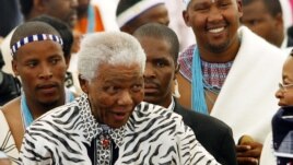 Former South African President Nelson Mandela, centre, followed by his grandson Mandla Mandela, rear right, arrives at a ceremony in Mvezo, South Africa, April 16, 2007.