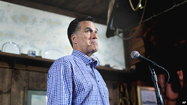 Republican presidential candidate, former Massachusetts Governor Mitt Romney holds news conference after talking with local business owners at a town hall meeting in Hampton, New Hampshire, July 5, 2011