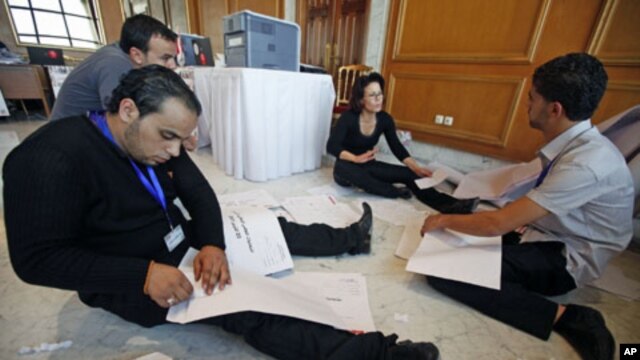 Workers in the independent commission tabulate votes in Tunisia after the country's general elections at a counting center in Tunis, Tunisia, October 24, 2011.