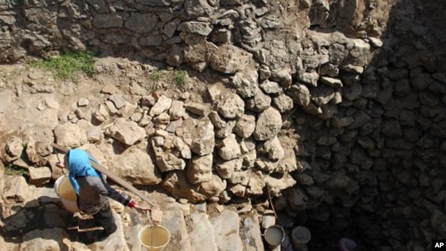 A farmer carrying water collected from a nearly dried-up well climbs a stairs at a village in Xiping county, Yunnan province, February 22, 2012.