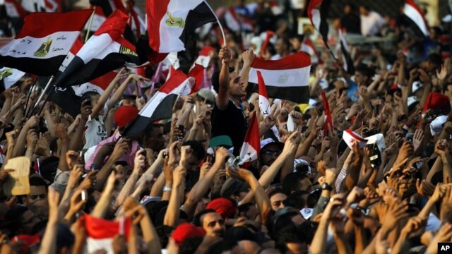 Egyptians listen to the speech of Egypt's President-elect Mohamed Morsi, in Tahrir Square in Cairo, Egypt, Friday, June 29, 2012.