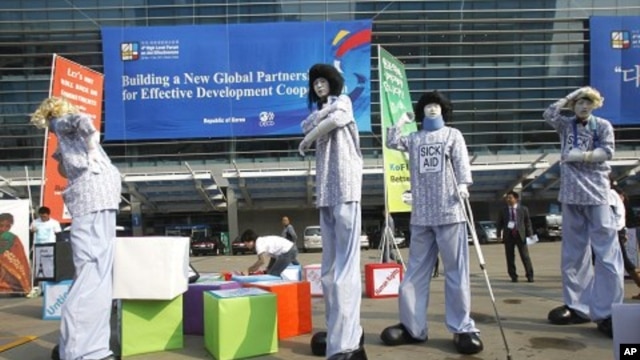 Members from Save the Children and World Vision demonstrate for for effective aid in front of the venue of the fourth High-Level Forum on Aid Effectiveness in Busan, South Korea, November 29, 2011.
