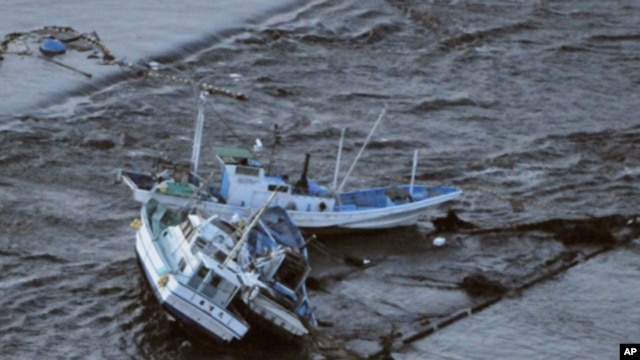 Fishing boats are swept by a tsunami in Oarai City in Ibaragi Prefecture, northeastern Japan March 11, 2011.