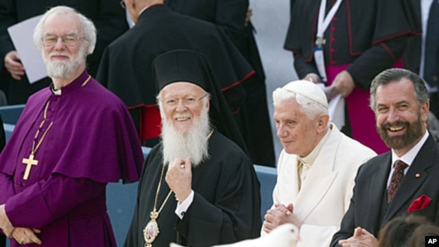 From left, Canterbury Archbishop Rowan Douglas Williams, Ecumenical Patriarch Bartholomew I, Pope Benedict XVI  and Rabbi David Rosen look on as a person holds a dove released during a peace meeting in front of the St. Francis Basilica in Assisi, central 