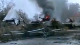 A Syrian military tank is shown as having caught fire outside Deir Ezzor in this January 29, 2013, file photo.