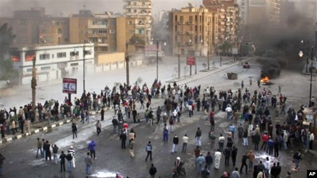 Egyptian protesters during clashes with anti-riot policemen in Suez, Egypt, Jan. 27, 2011
