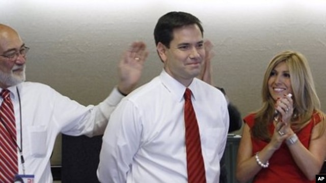 Republican Florida Senator-elect Marco Rubio and his wife Jeanette smile as national TV stations call the race in his favor while watching results in Coral Gables, Florida, 2 Nov. 2010