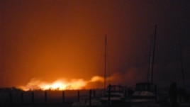 A fire burns dozens of homes in a flooded neighborhood in the borough of Queens, New York, Oct. 30, 2012.