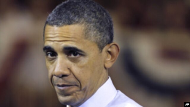 President Barack Obama pauses while speaking at Scranton High School in Scranton, Pa., Wednesday, Nov. 30, 2011.