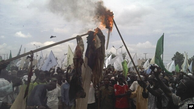 Muslims burn a US flag and a portrait of U.S. President Barrack Obama following a protest in Kano, Nigeria, September 22, 2012.