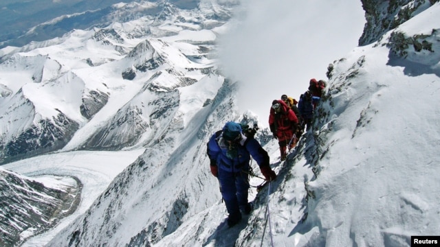 FILE - A team of mountaineers is seen climbing Mount Everest.