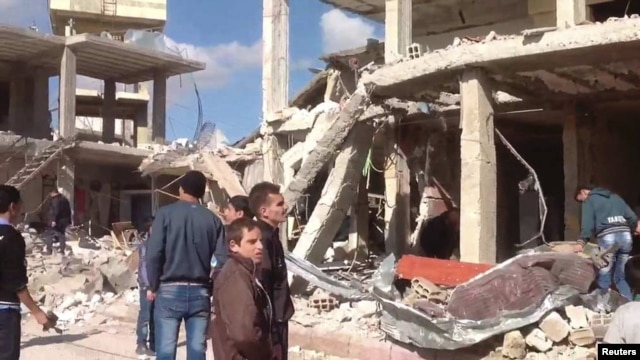 A damaged area is pictured after a car bomb in Qatana, near Damascus December 13, 2012 in this handout photograph released by Syria's national news agency SANA.