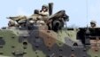 FILE - U.S. Marines from the 3rd Marine Expeditionary Brigade ride on an amphibious assault vehicle during assault exercises with Philippine marine troops in joint drills, Oct. 9, 2015.